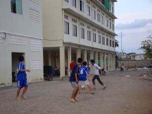 Cambodian Students who stay in dorm are playing football in front of their building in the evening / Photo by: Koam Tivea